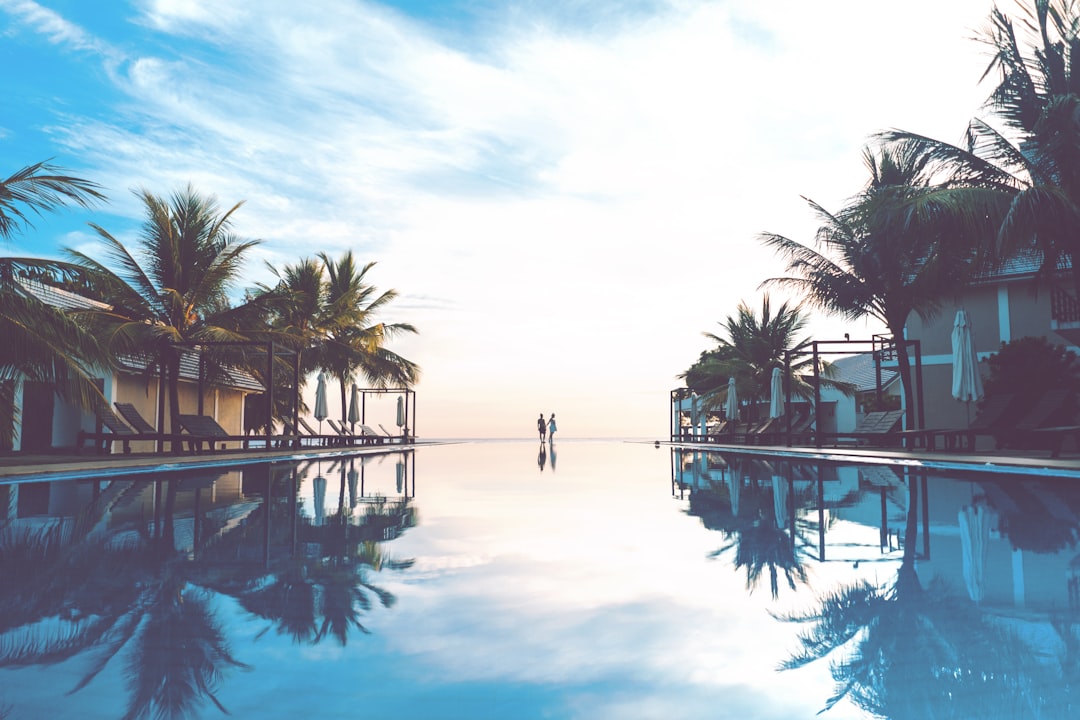two person standing beside swimming pool - Photo by Marvin Meyer on Unsplash
